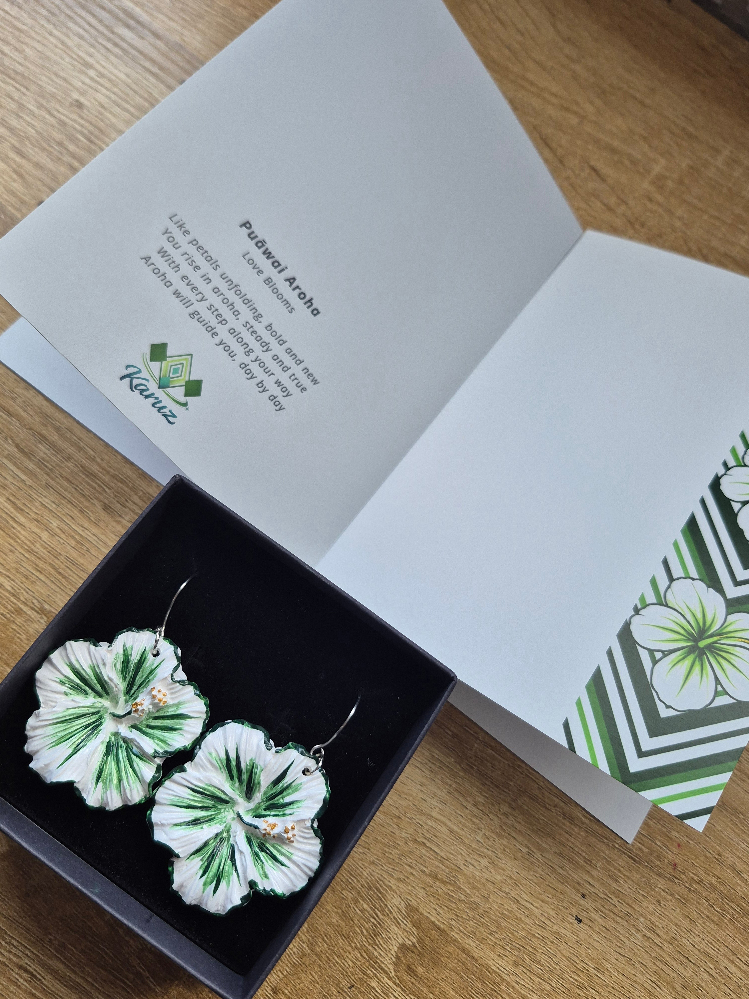 Floral drop earrings in black gift box, green-and-white flower design