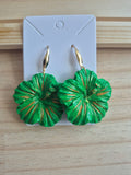 Green hibiscus flower drop earrings with gold-tone hooks, pair