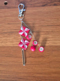 Red star charm keychain with pink round beads and metal clip, on chain
