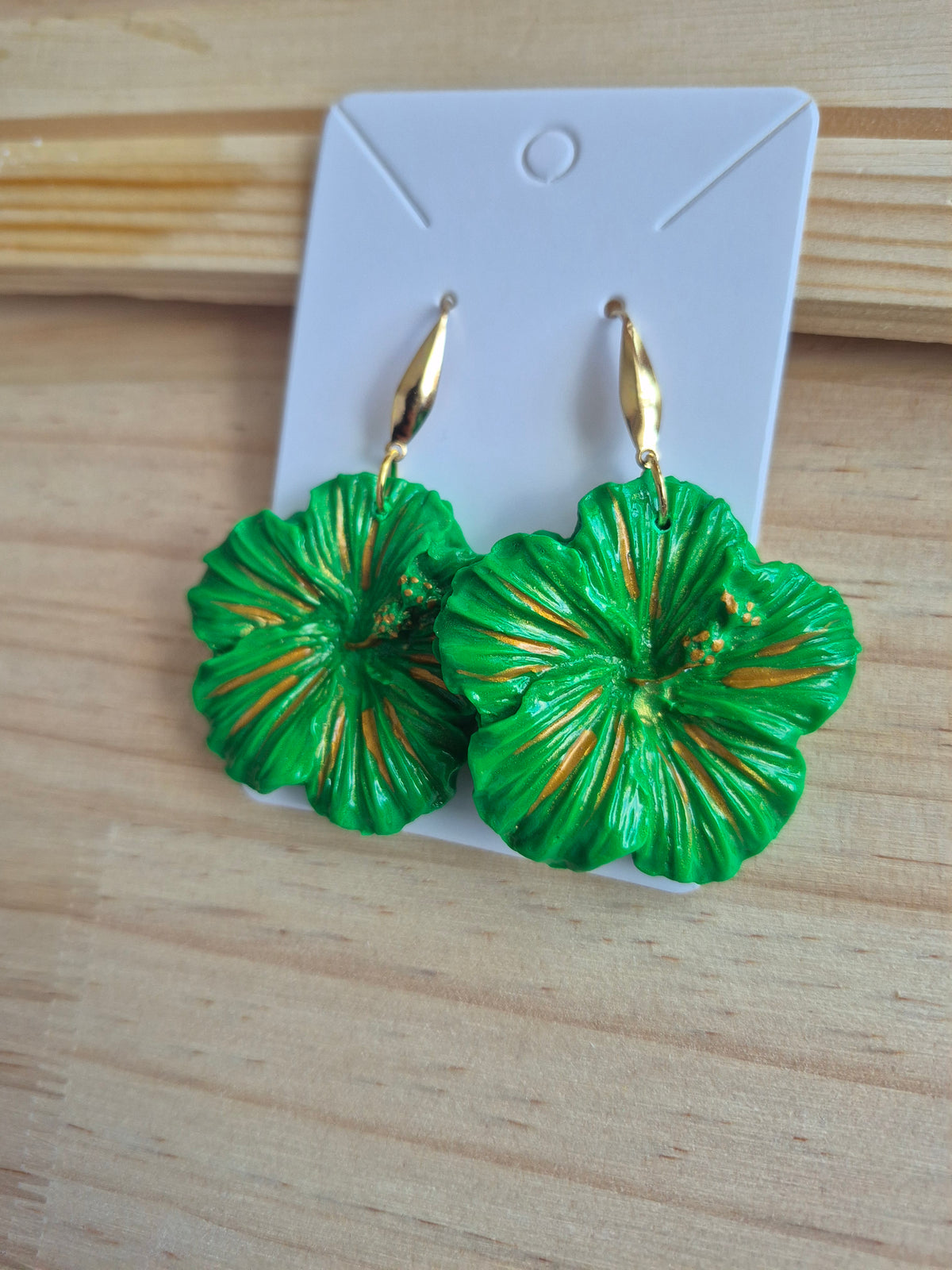 Green hibiscus flower drop earrings with gold-tone hooks