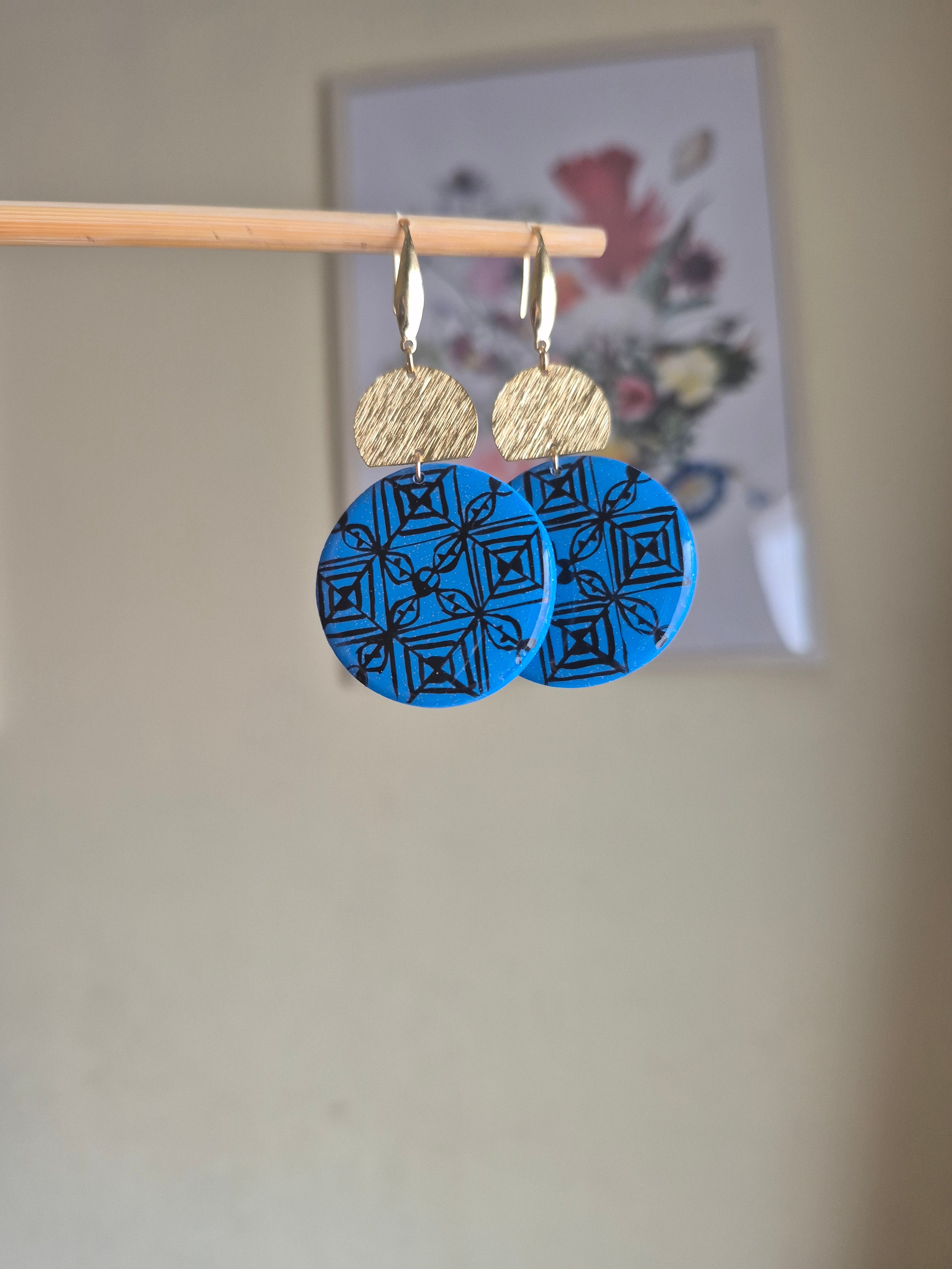 Blue and tan geometric disc earrings with gold hooks, layered round design