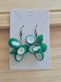 Green and white flower drop earrings with circular leaf accents