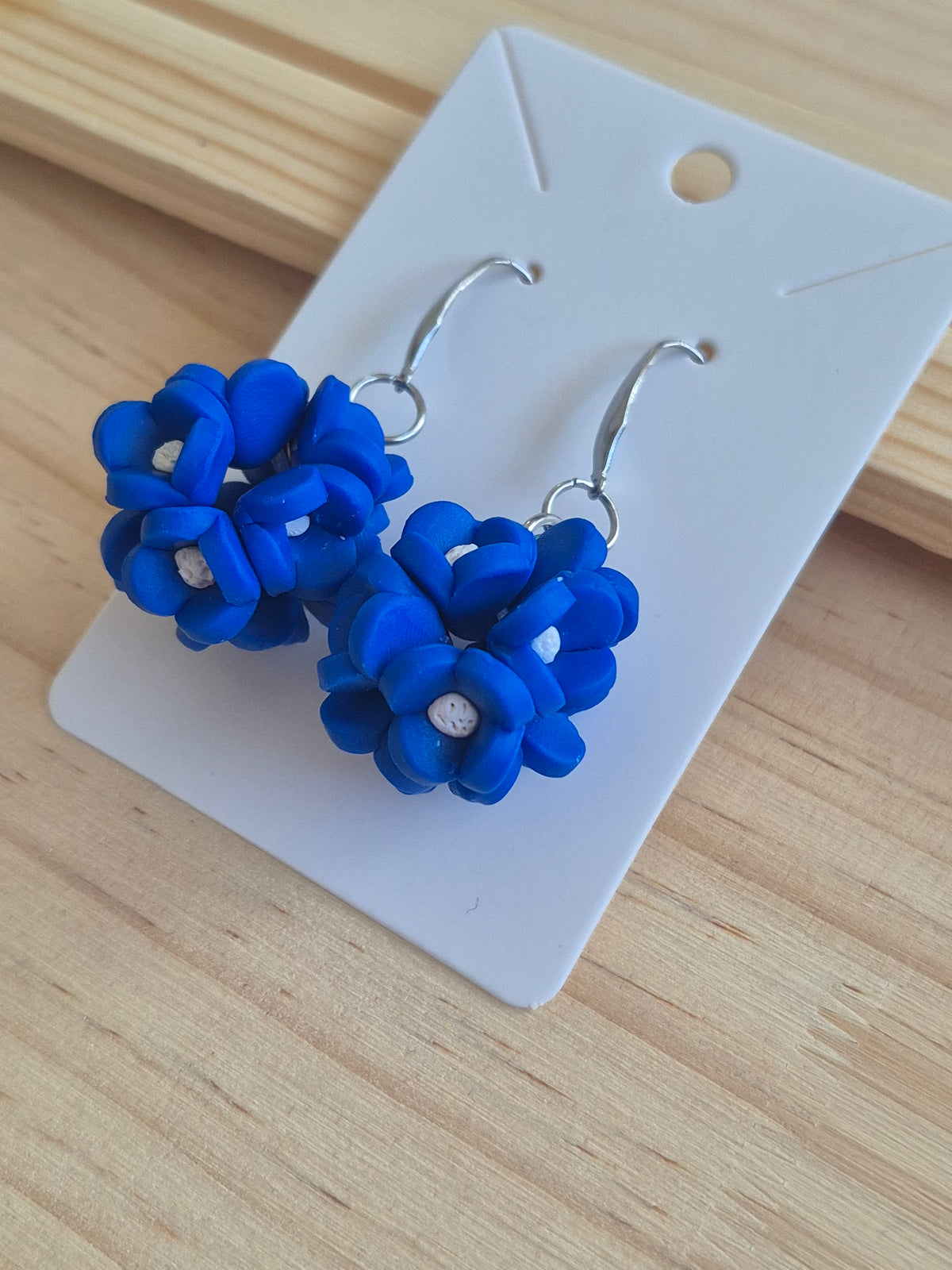 Blue fabric flower dangle earrings with silver-tone hooks