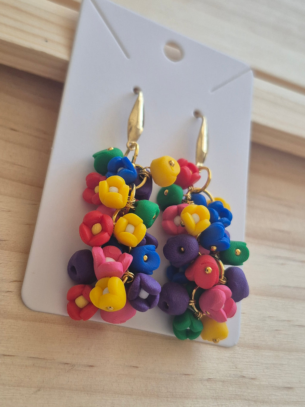 Rainbow bead cluster dangle earrings with gold-tone hooks, on display card