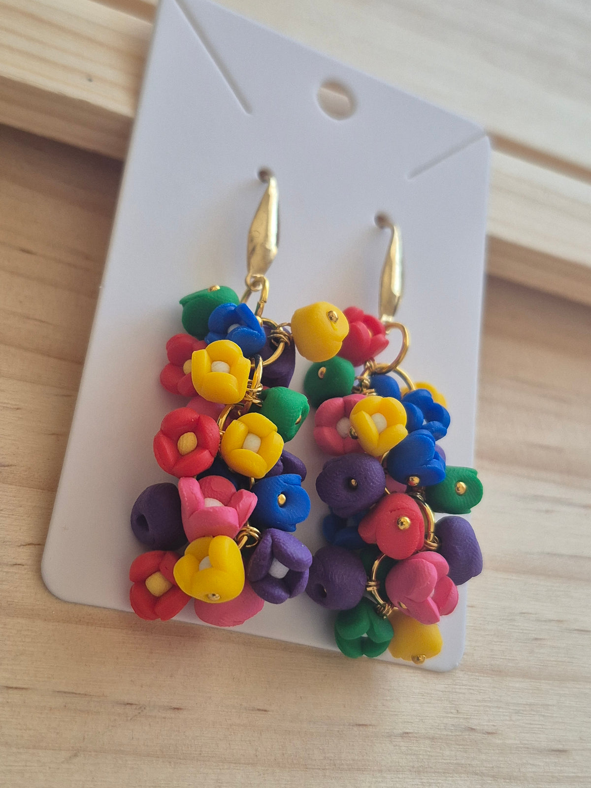 Rainbow bead cluster dangle earrings with gold-tone hooks, on display card