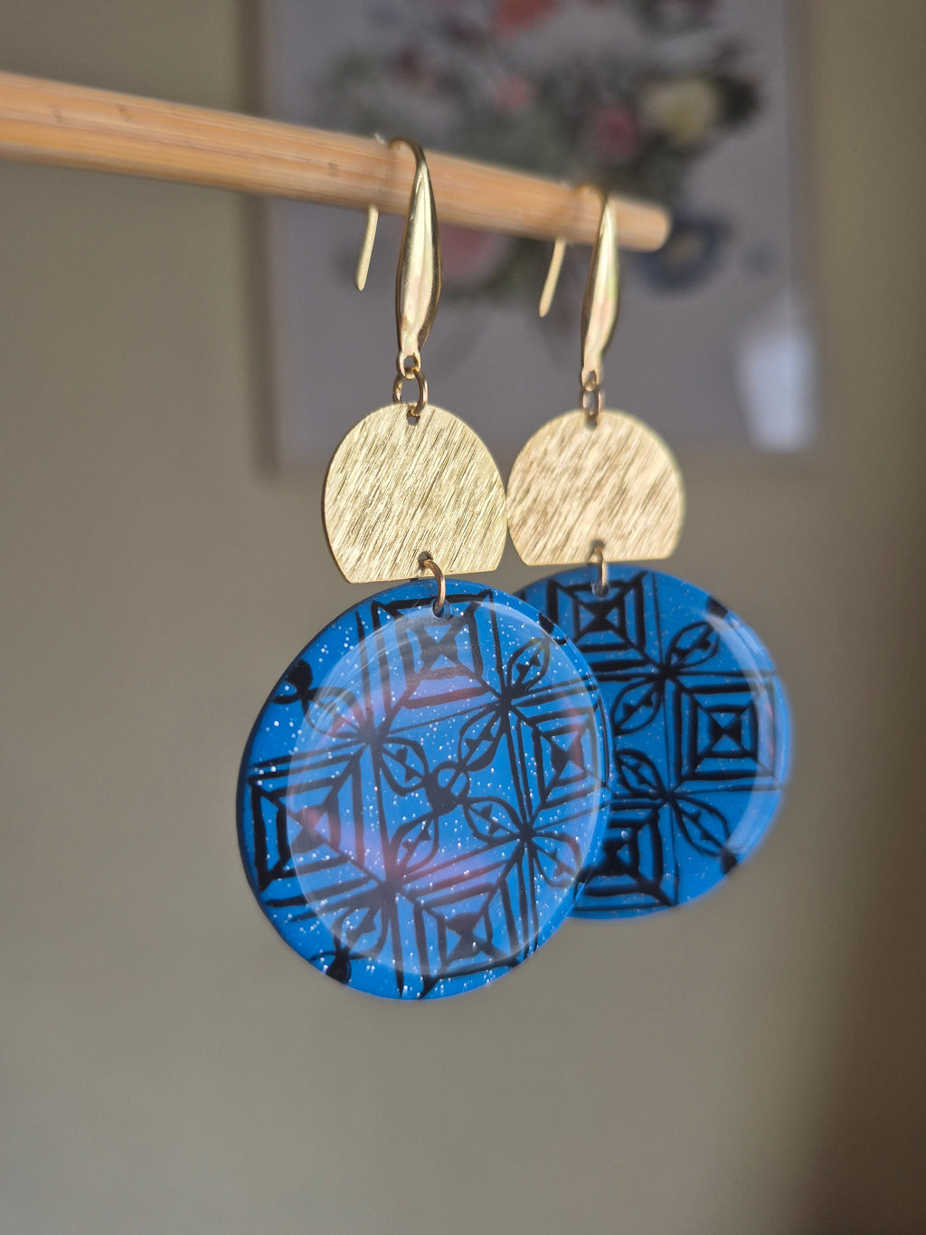 Blue geometric disc drop earrings with gold hooks and textured tan top discs