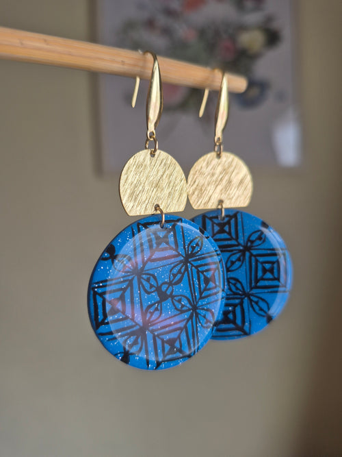 Blue geometric disc drop earrings with gold hooks and textured tan top discs