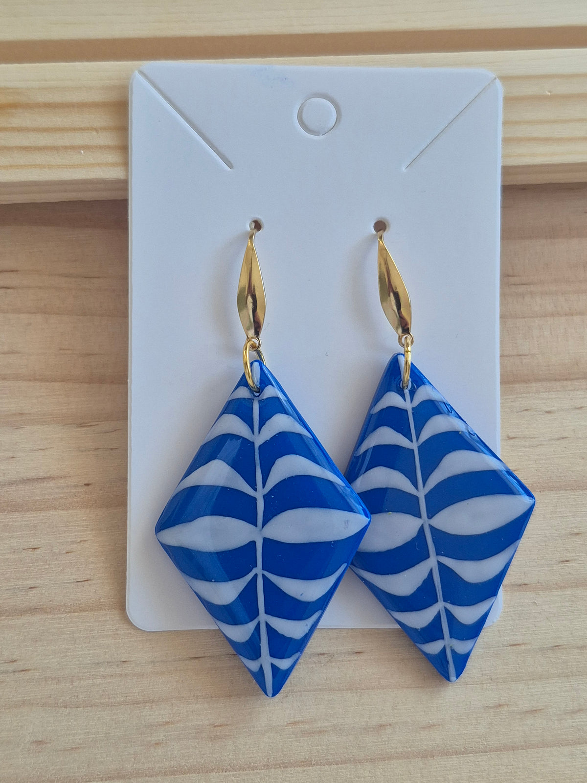 Blue and white patterned diamond drop earrings on gold hooks