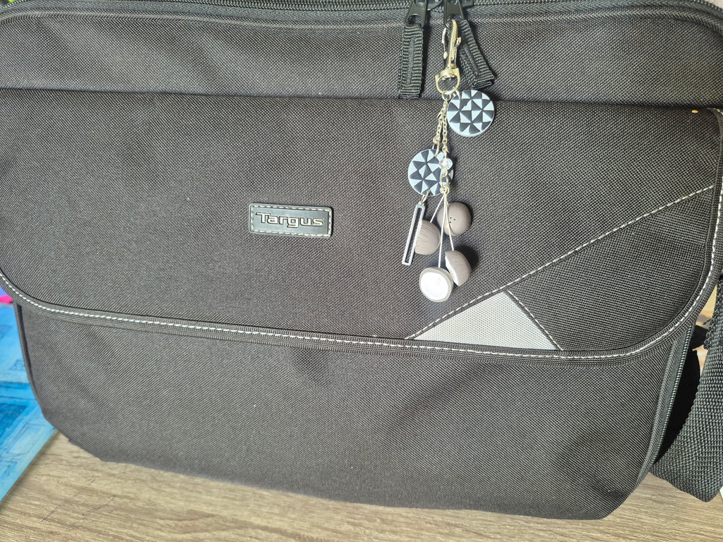 Navy and white geometric keychain with metal ring and small dangling charms