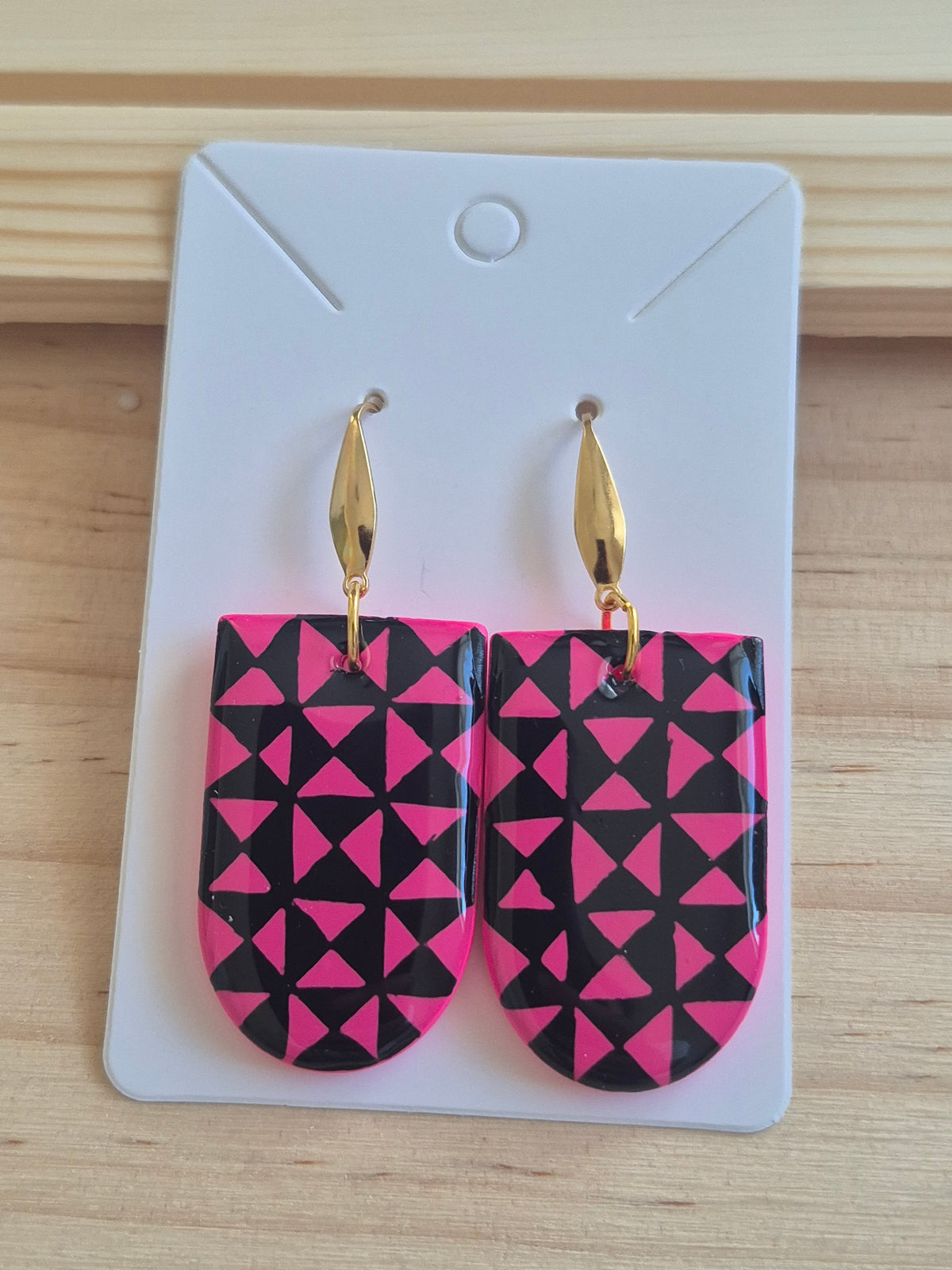 Geometric pink-and-black drop earrings with gold-tone hooks