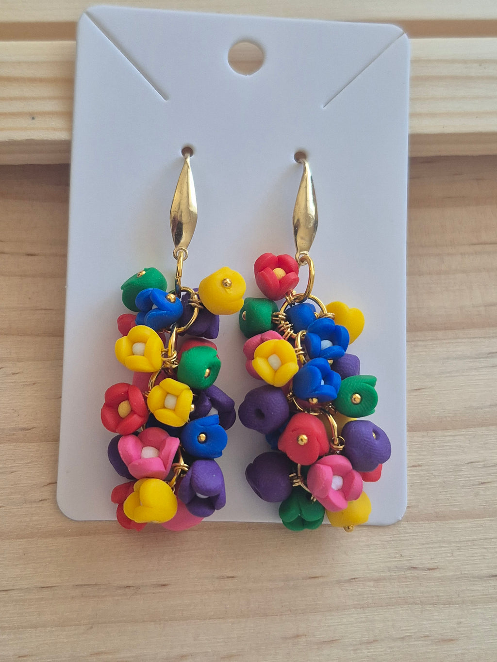 Rainbow bead dangle earrings with gold-tone hooks, on display card