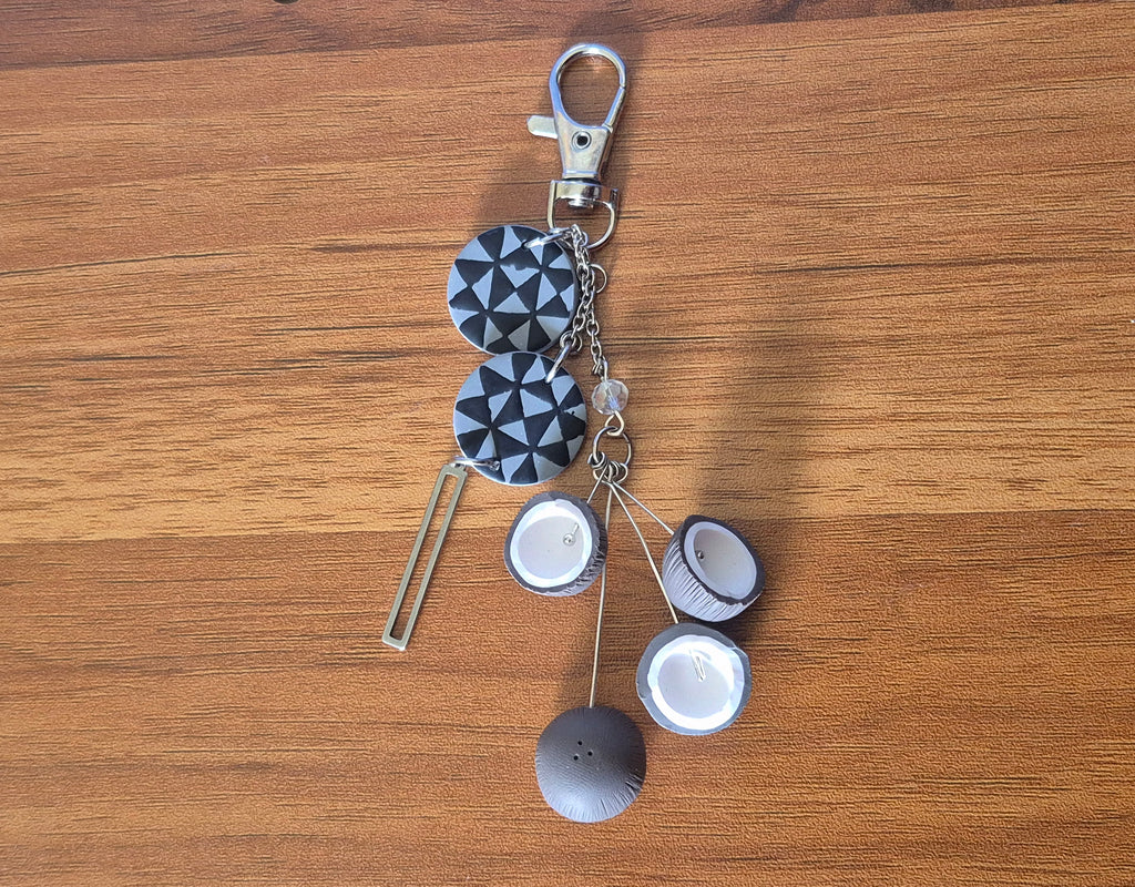 Navy and white geometric keychain with lobster clasp and round shell-like charms