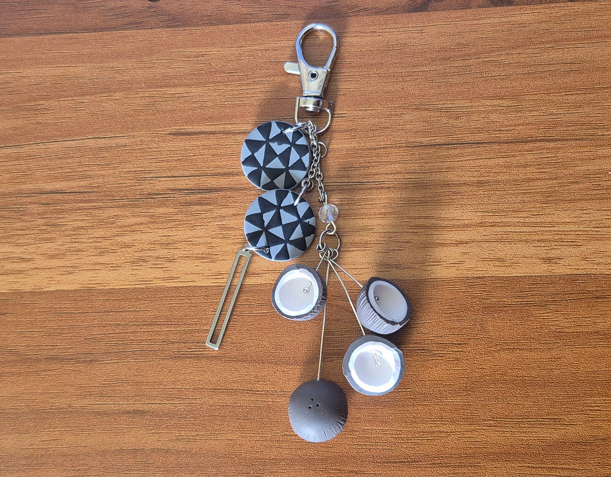 Navy and white geometric keychain with lobster clasp and round shell-like charms